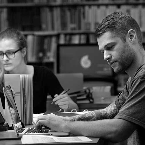 two students in the library studying